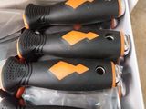 six black and orange kitchen knives in a box on a counter