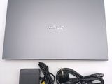 a laptop with a charger and a charger on the table