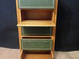 an image of a wooden bookcase with three drawers