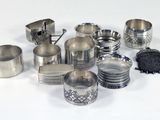 many different types of silverware on a white surface