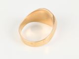 an image of a gold ring on a white surface