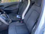 the interior of a car with the door open showing the driver ' s seat area