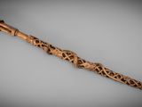 an old wooden stick with carvings on it sitting on a table