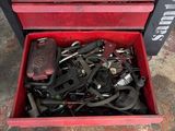 a red tool box filled with tools sitting on top of a floor