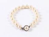 bracelet with white pearls and a silver clasp on a white background