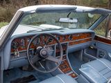 a blue car with a wooden dashboard and steering wheel
