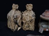 two figurines that are sitting next to each other