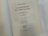 a book opened on a white surface with a red and black cover