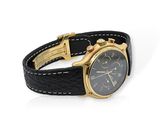 an image of a black and gold watch on a black leather strap