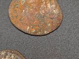 three old coins sitting on top of a table next to each other