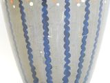 a vase that has a blue and orange design on it