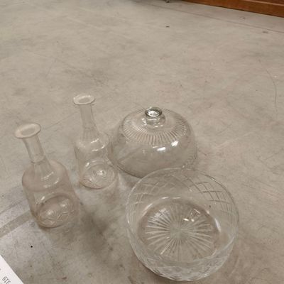 several glass vases and a bowl on the floor