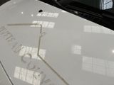 a close up of a white car with a sticker on it