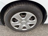 a close up of a tire on a white car