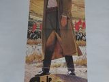 affiche représentant un homme en trench-coat debout devant un champ