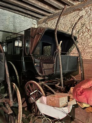 a horse drawn carriage in a room with a brick wall