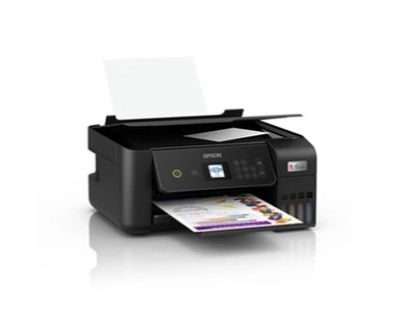 the printer is sitting on a white surface with a paper in front of it