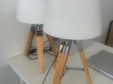 two lamps sitting on a table with a laptop on it