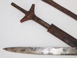 two old knives on a white surface next to each other