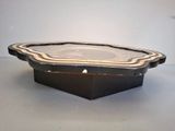 a black and white tray with a lid sitting on a table