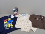 three t - shirts and a camera on a couch