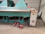 a machine that is sitting on the floor in front of a building