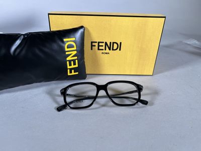 fendi eyeglasses in a box and a pair of glasses on a table