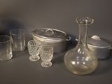 bottles and glasses are sitting on a table next to a pot and pan