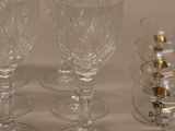 many wine glasses sitting on a table next to each other
