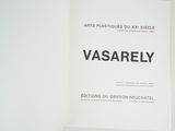 a white book with black writing on it sitting on a shelf