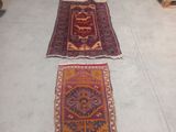 several rugs are lined up on the floor in a room
