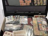 a suitcase full of stamps and other items in it