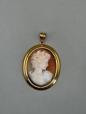 a close up of a picture of a woman ' s face in a gold frame