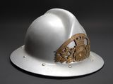 a white helmet with a gold emblem on it