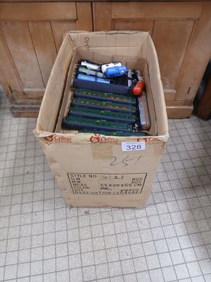 a box full of toothbrushes sitting on the floor
