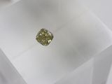 a close up of a yellow diamond in a clear box
