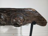 a wooden sculpture of a bird on a metal stand