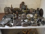 a white shelf with a lot of antique items on it