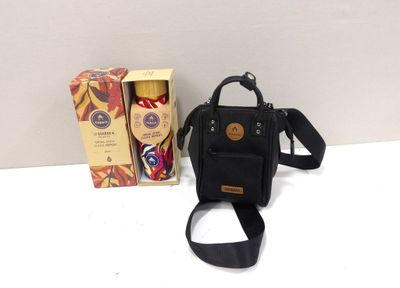 a small black bag with a black strap next to a box of coffee