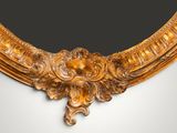 an ornately carved gold frame with a black background