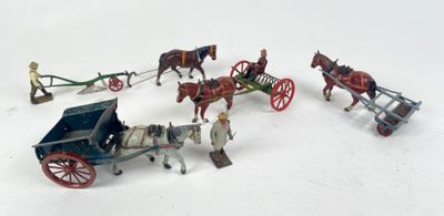 a group of toy horses pulling a carriage with a man on it