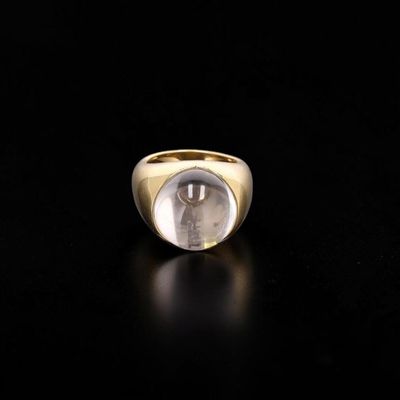 a close up of a gold ring with a picture of a man in a glass