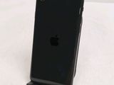 a black iphone that is sitting on a stand