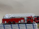 a red fire truck that is sitting on top of a box