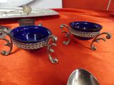 two bowls and spoons sitting on a table