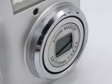 a silver digital camera sitting on a white surface