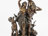 a bronze statue of a woman and two children with a dog