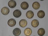 several coins are arranged in a circle on a white surface