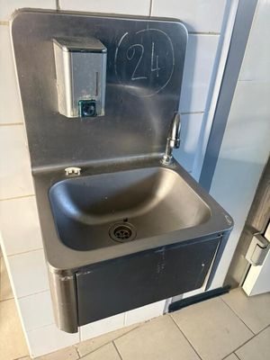 a stainless steel sink in a public restroom