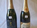 two bottles of champagne sitting next to each other on a table